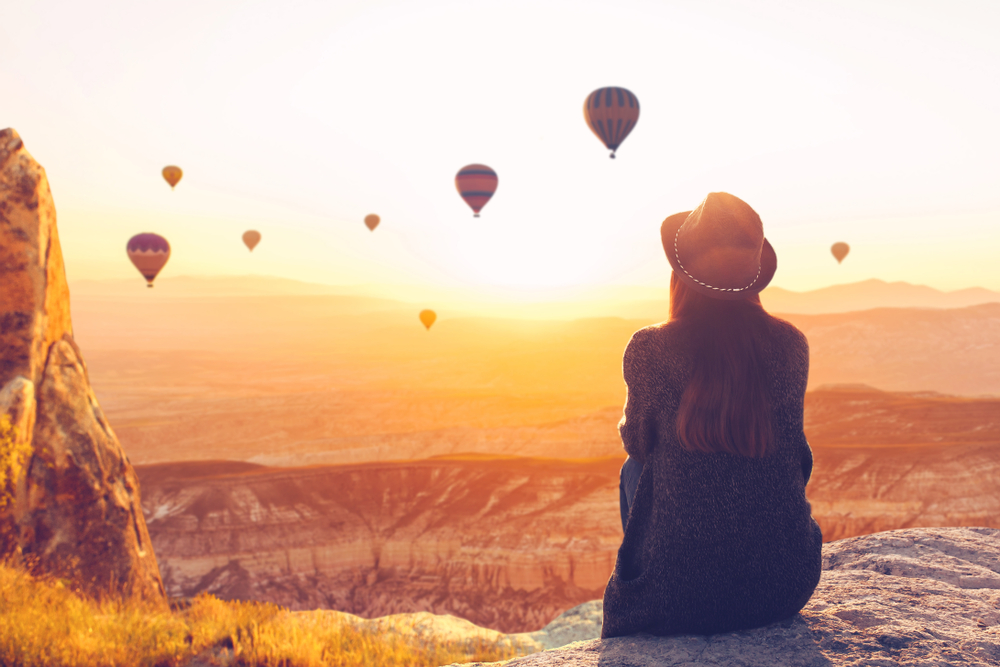 A,Woman,Alone,Unplugged,Sits,On,Top,Of,A,Mountain